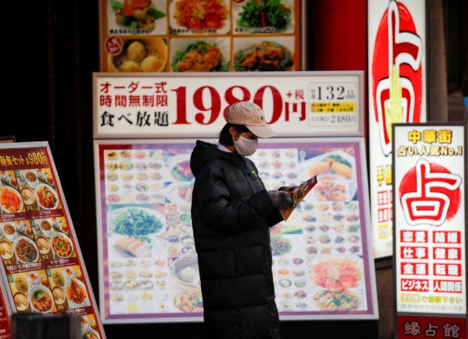 横浜の中華街でマスク着用で店頭に立つレストランの従業員