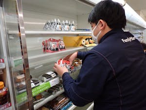 営業が再開した「ファミリーマート輪島横地町店」で、おにぎりの陳列作業を行う店員