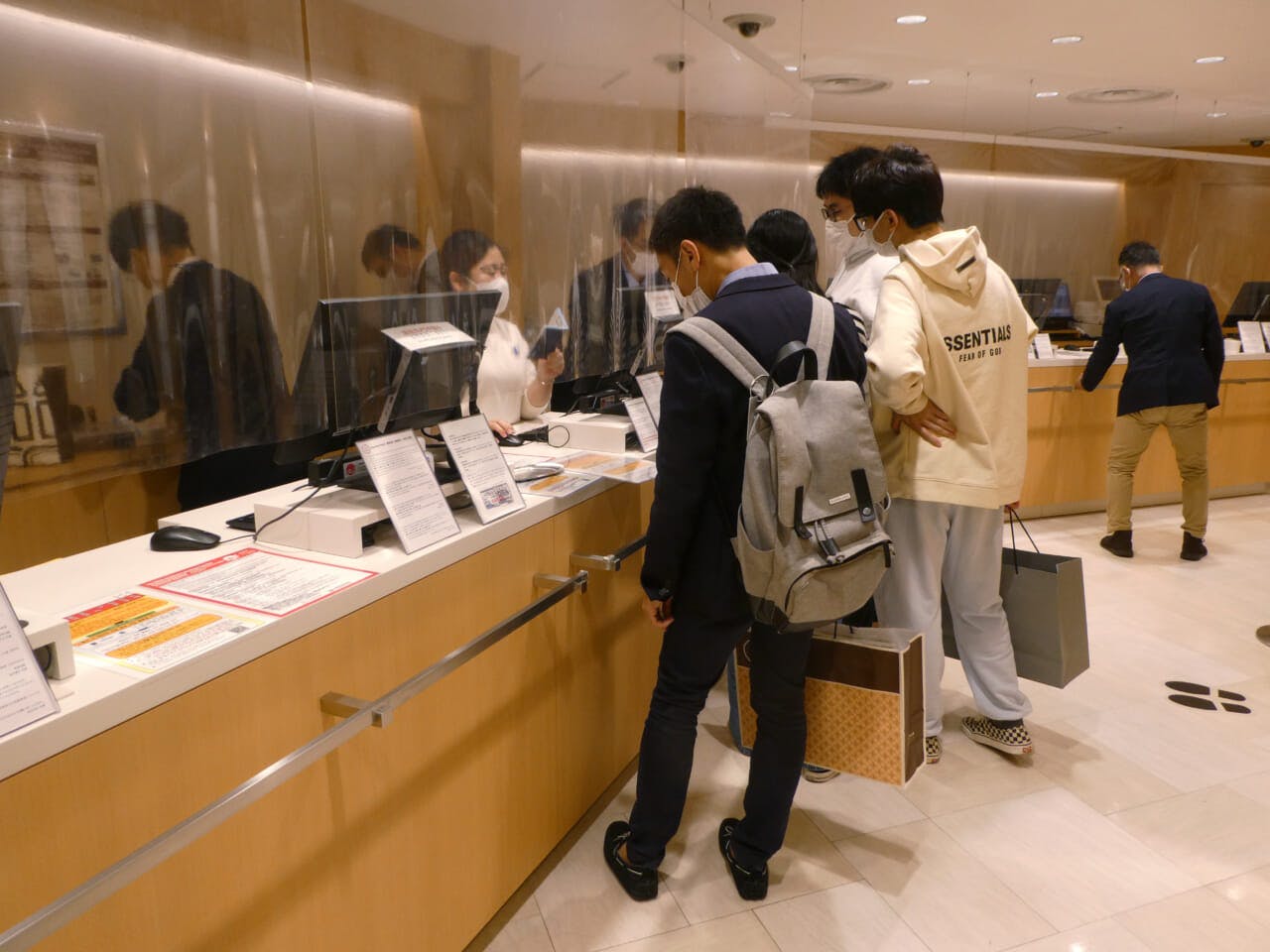 松屋銀座の免税カウンターで手続きをする訪日外国人旅行者ら