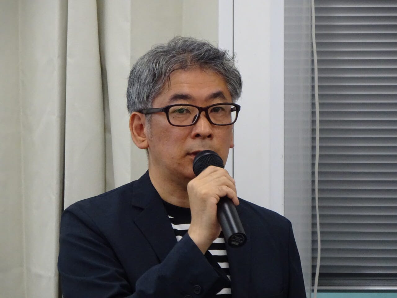 説明会に臨む良品計画ソーシャルグッド事業部執行役員の長田英知氏