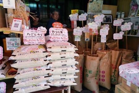 精米店の店頭に積み上げられたコメ